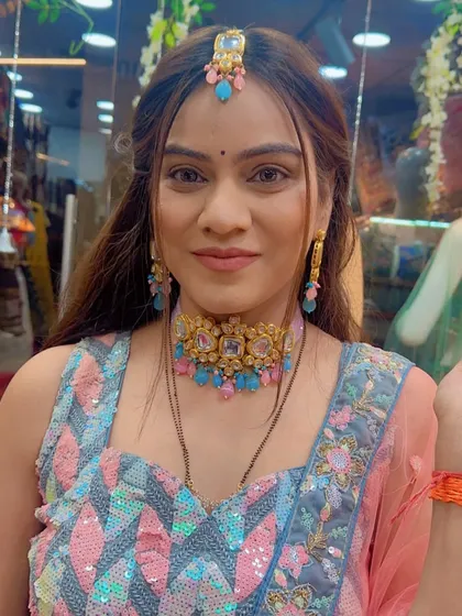 A close-up of a client wearing a modern lehenga with a geometric sequin blouse in shades of pink and blue.