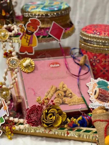 A close-up of a Lohri gift set, featuring decorated boxes and traditional sweets. This is a perfect, compact gift for the festive season.