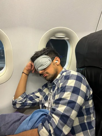 The reality of a destination DJ: catching sleep on a flight between gigs. The hustle is real, but the energy of the crowd makes it all worth it.
