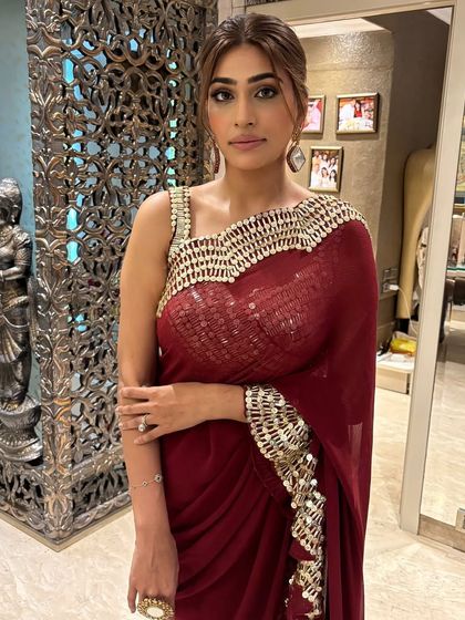 This deep maroon saree with a statement border is perfect for a more formal evening event. The color is rich and the embroidered border adds just the right amount of glam.