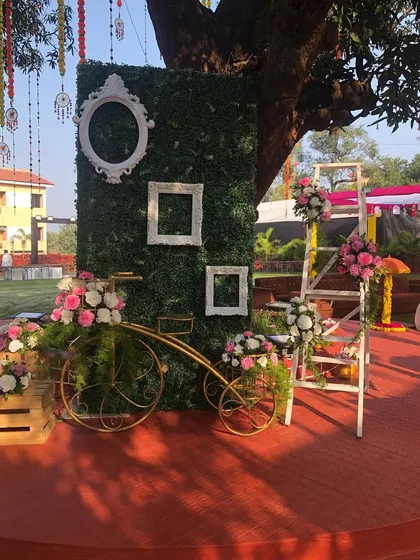 A Haldi ceremony is all about fun and color. We created this vibrant photo corner with a lush green wall, decorative frames, and a flower-adorned vintage bicycle to give guests a beautiful spot for pictures.