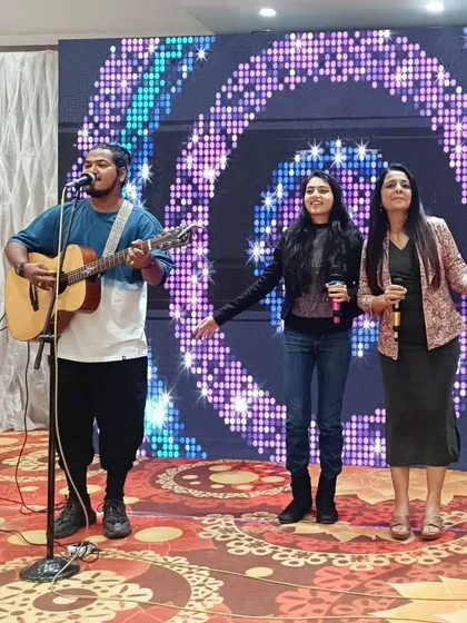 Singing along with the band and a young guest. I love to encourage participation and make the entertainment interactive for all age groups.