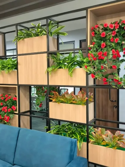 For this office, we created a functional and beautiful partition wall using a combination of artificial foliage and flowering plants. This is an excellent solution for dividing spaces while maintaining an open, green feel without any maintenance.