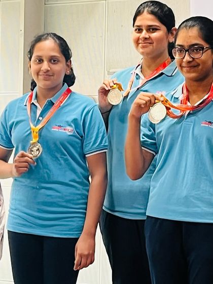 Our senior and youth women's pistol team celebrating their silver and bronze medal wins.
