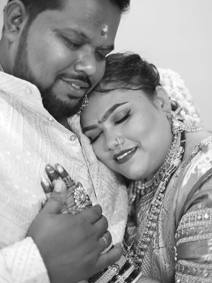 A beautiful black and white shot of a bride and groom, capturing a tender moment after the wedding.
