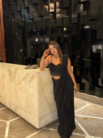 A moment of pause in my favorite black saree. It's my go-to choice for a look that is both sophisticated and effortlessly chic.