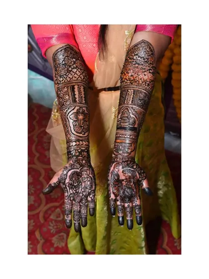 The final, dark-stained result of a full-arm design, proudly displayed by the client.