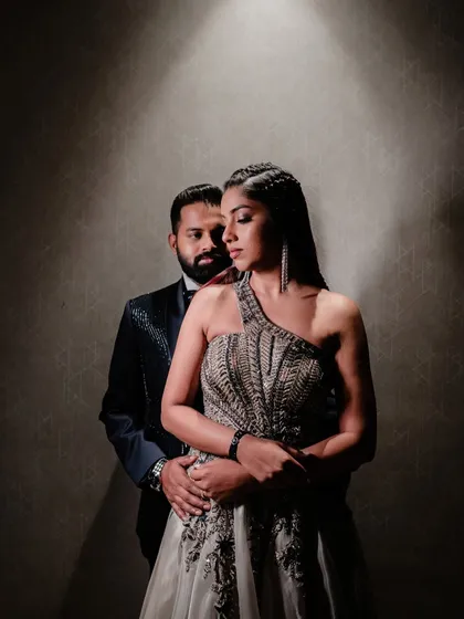 Using dramatic lighting to create a moody and romantic portrait. This shot captures the couple's connection and the stylish atmosphere of their after-party celebration.