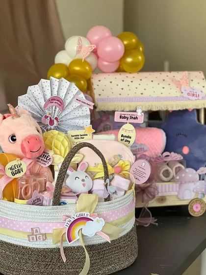 It's a girl! I adore creating these dreamy hampers in shades of pink and purple. This set includes a cozy basket filled with soft toys and essentials, alongside a whimsical trolley hamper, all designed to welcome a little princess in the most beautiful way.
