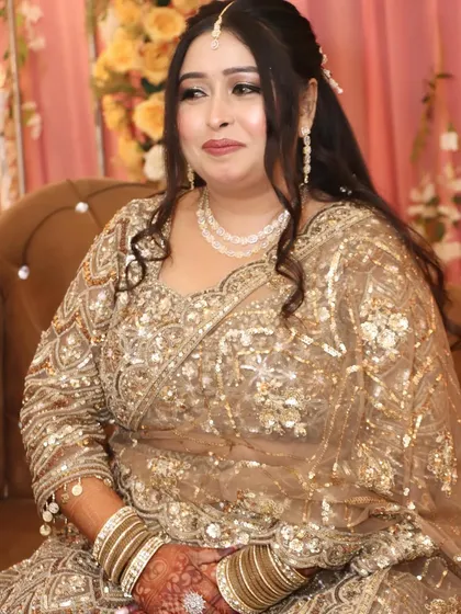A regal pose showing off the intricate details of her engagement look. The makeup is bold yet elegant.