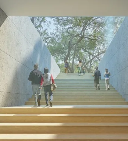 A grand staircase at the Qutub-Shahi Centre, designed to lead visitors up towards the park. The angled walls frame the view of the trees, creating a powerful sense of arrival and connection to nature.