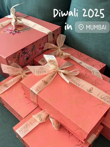 Here are my Diwali hampers all packed and ready to go. I love how the pretty pink boxes with floral designs and gold foil look when they are all stacked up. Each one is tied with a ribbon, making it feel like a truly special gift.