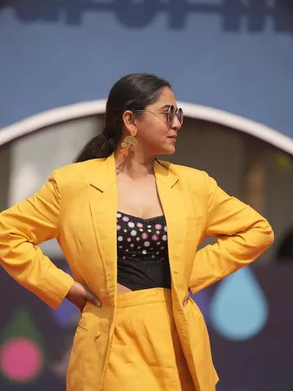 A close-up of the IFFI Goa look, showing the contrast of the polka-dotted top with the solid yellow suit, adding a playful yet stylish element to the ensemble.