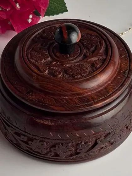 For a truly unique gift, this handcrafted wooden box comes with four cavities filled with premium dry fruits and two decorative Laddoo candles.