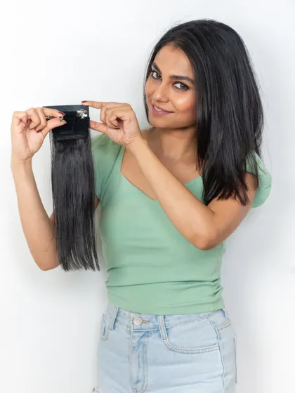 Here is a closer look at the clip mechanism on our side bangs. The small but sturdy clip ensures the extension stays in place all day while being comfortable to wear.