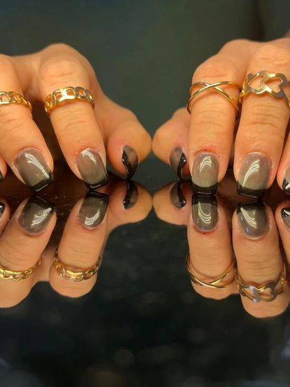 A modern and chic design with a grey base and a black French tip.