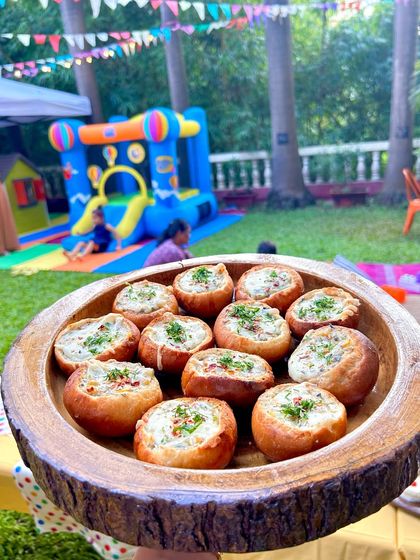 Another tempting shot of the veggie buns, with the party's bouncy castle in the background. Fun food and fun games are the perfect combination.