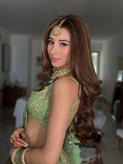 A beautiful portrait that highlights her glowing skin and the minimal, elegant jewelry. This is a perfect example of modern Mehendi makeup.