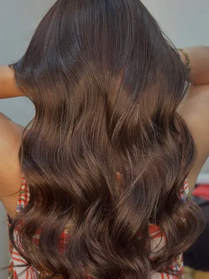 Holding up the healthy, wavy locks to show off the rich, no bleach color.