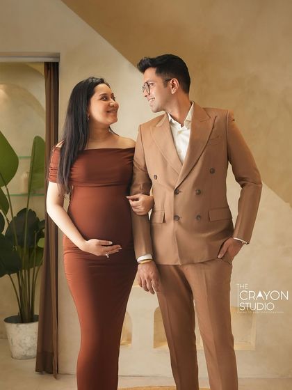 An elegant couple poses in my studio. Their formal attire and the sophisticated, neutral background create a look that is both modern and timelessly chic.
