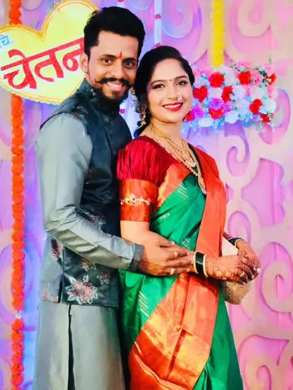 A happy couple at their engagement ceremony, looking perfectly matched and radiant.