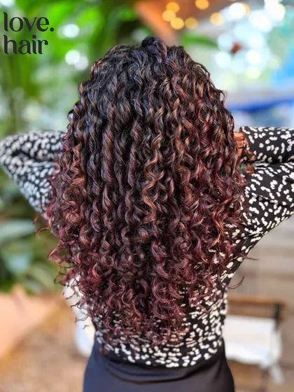 Finger coiling at its best. We used this technique to define and shape our client's curls after applying a non-bleach color for a subtle red-brown tint.