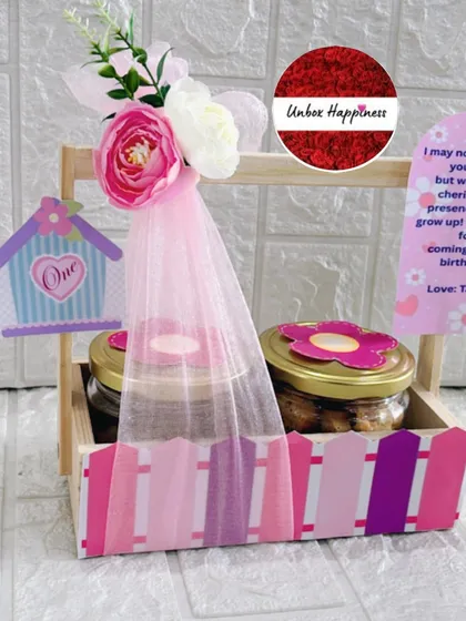 This first birthday return favor features a pink birdhouse theme, with jars of treats and a personalized thank you note from the birthday girl, Taarini.