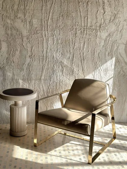 This lounge chair concept explores the interplay between solid and void. We crafted a light, airy structure from metal with a polished gold finish, contrasting it with the clean lines of the neutral-toned upholstery to achieve a sense of refined, modern elegance.