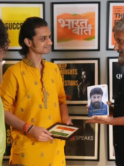 Receiving a copy of 'The Book of Life' from Vivek Agnihotri. His support for '18 Days' and our work at Prabhat Arts International is truly inspiring.