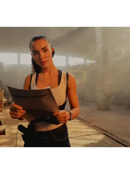 A film still of Amy Jackson as Patricia Novak in 'CRAKK'. Her look, featuring a tactical harness over a simple tank, was designed to be both functional for action sequences and visually define her character.