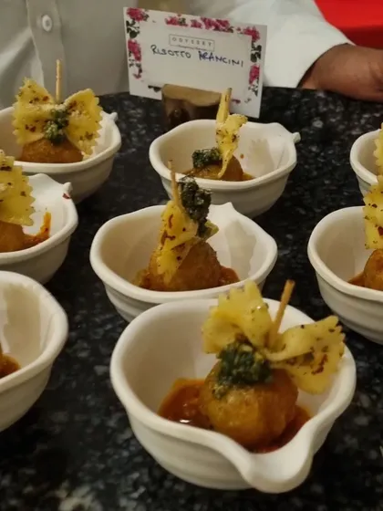 Every detail matters in fine dining. Our risotto arancini are individually plated and garnished with a pesto-topped farfalle, showcasing the meticulous care we put into every single dish we serve, whether passed or plated.