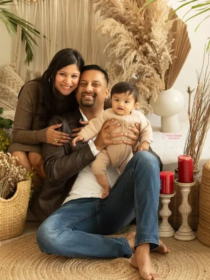 A classic portrait of a young family in my cozy, boho-themed studio. The warm, earthy tones create a relaxed setting for beautiful family photos.