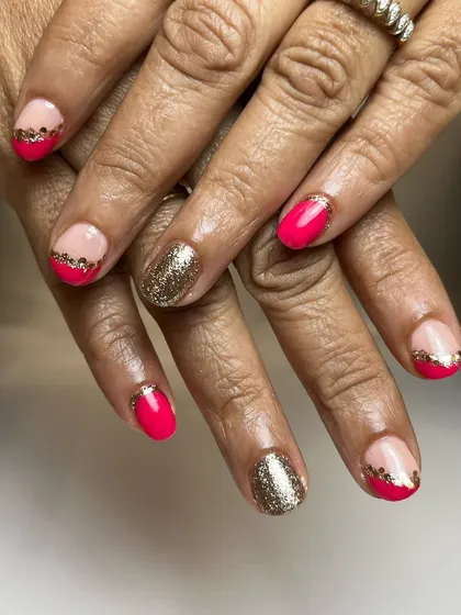 Proof that you don't need long nails for beautiful art. This design on short, natural nails features a bright pink polish with gold glitter accents.