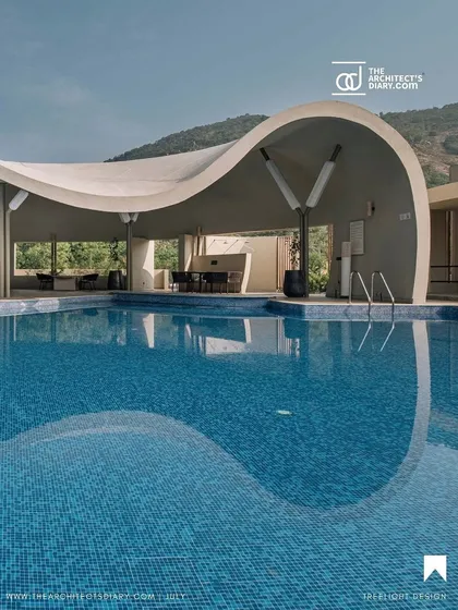 The Architect's Diary captured this beautiful reflection of the Aqua project's curved roof in the pool, emphasizing the design's fluid geometry.