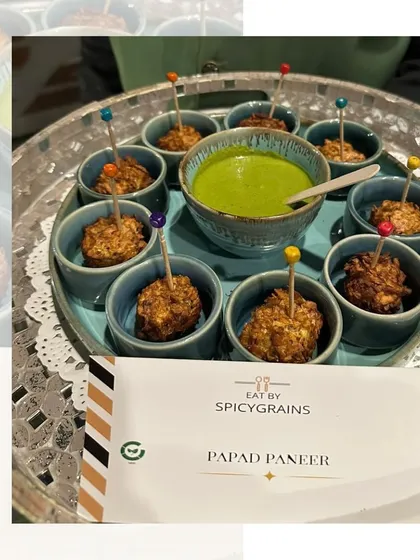 Our Papad Paneer bites, individually served in small blue bowls with a side of green chutney. The colorful skewers add a fun touch to this crunchy and savory snack.