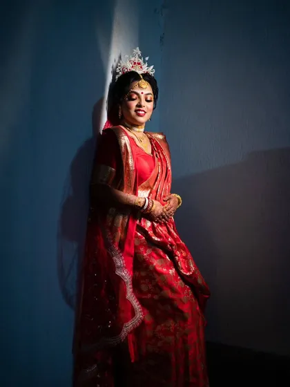 An artistic bridal portrait using dramatic lighting to create a serene and elegant mood.