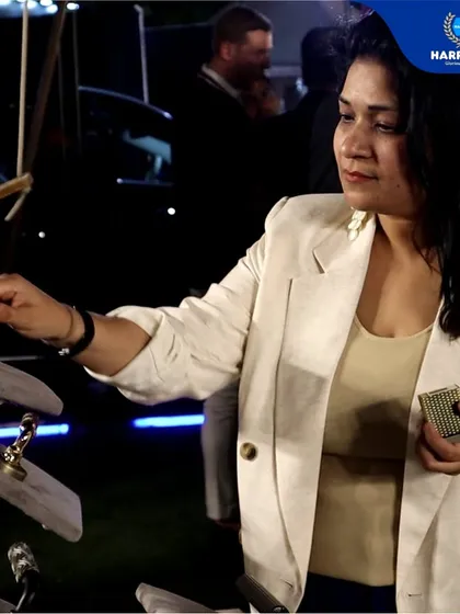 An attendee at the Delhiites Food & Nightlife Awards interacts with my display of premium door handles. It's always rewarding to see people experience the tangible quality and craftsmanship of my products.
