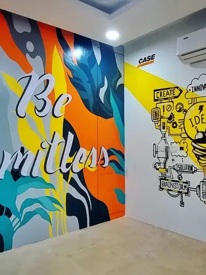 A two-part mural for an office space. One side features a vibrant, abstract design with the words 'Be Limitless', while the other has a doodle-style graphic about ideas and innovation.