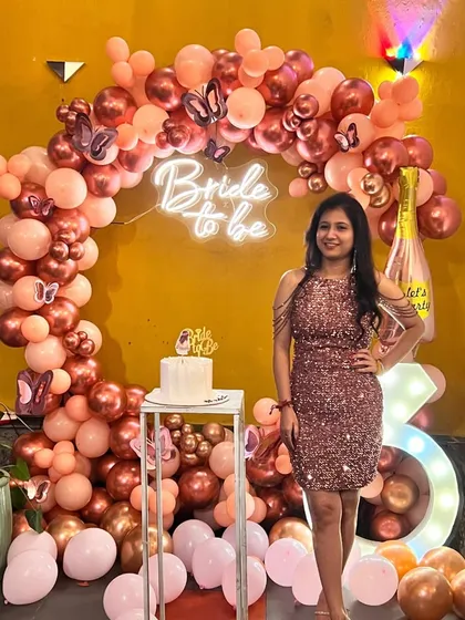 The birthday girl and bride-to-be posing with her cake in front of the rose gold balloon backdrop. I can also provide cake stands to complete the look.
