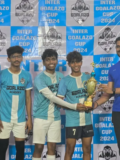 The Under-19 team proudly accepts their trophy from the coach at the Inter Goalazo Cup.
