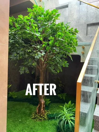 An 'after' shot of an indoor courtyard space under a staircase. I used a realistic artificial Ficus tree and faux grass to create a maintenance-free green corner that looks great year-round.