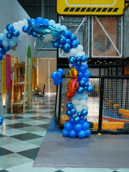A magnificent 'Under the Sea' balloon archway, complete with shark, octopus, and seahorse balloons, makes for a grand entrance.