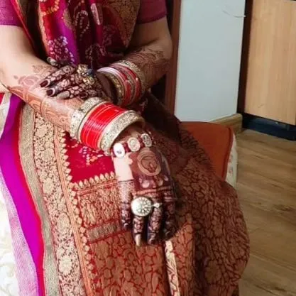 An elegant shot showcasing the stained portrait mehendi and bridal jewelry.