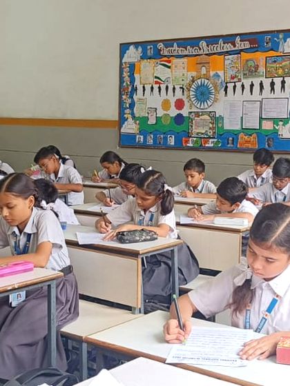 Students deeply focused on the handwriting competition during the 2023 Olympiad at Gayatri Public School.