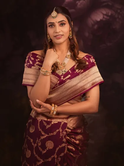 Sapthami's pose is one of modern confidence, yet her traditional Banarasi saree roots her in timeless elegance.