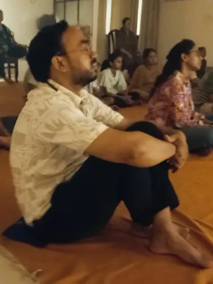 A participant sits in deep meditation during the Amavasya rituals. These nights are potent for dissolving limitations and connecting with a deeper dimension of life.