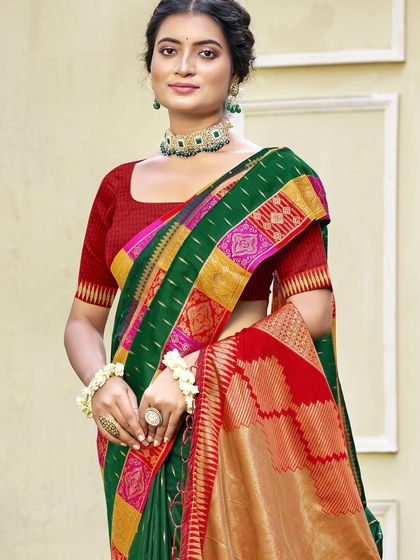 This bottle green Dupion silk saree is a classic beauty. The rich color and traditional border make it a perfect choice for any formal or festive occasion.