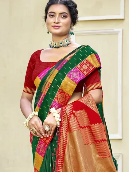 This bottle green Dupion silk saree is a classic beauty. The rich color and traditional border make it a perfect choice for any formal or festive occasion.