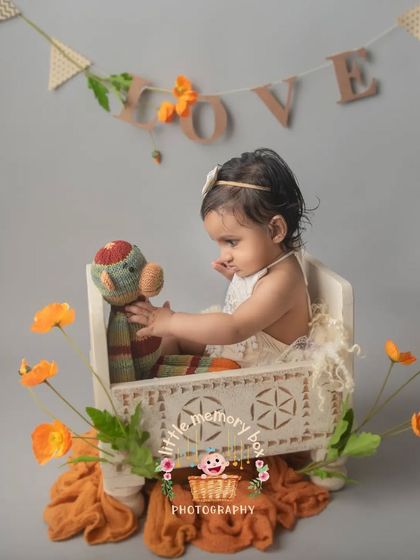 Six months is such a fun age. This little one is enjoying a playful moment with a stuffed toy in one of my prop beds. The "LOVE" banner adds a sweet touch to the setup.