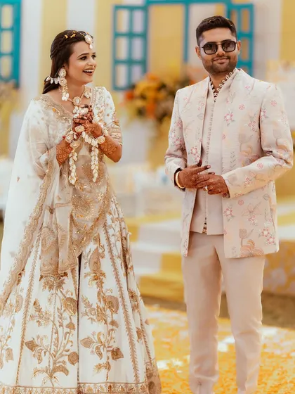 A full shot of the couple, showcasing their beautiful and coordinated Haldi outfits.